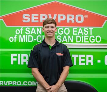 Man standing in front of a green background with SERVPRO logo.