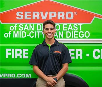 Man standing in front of a green SERVPRO background.