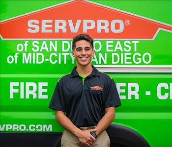 Man standing in front of a green SERVPRO background.