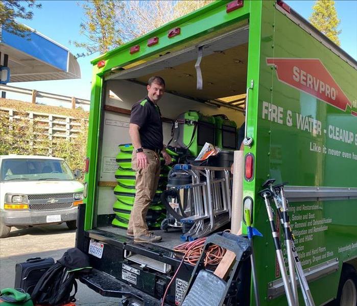 Team member in the back of a SERVPRO van.