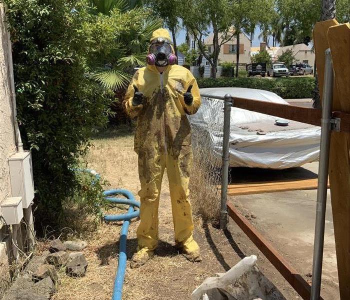 technician in vtec suit muddy