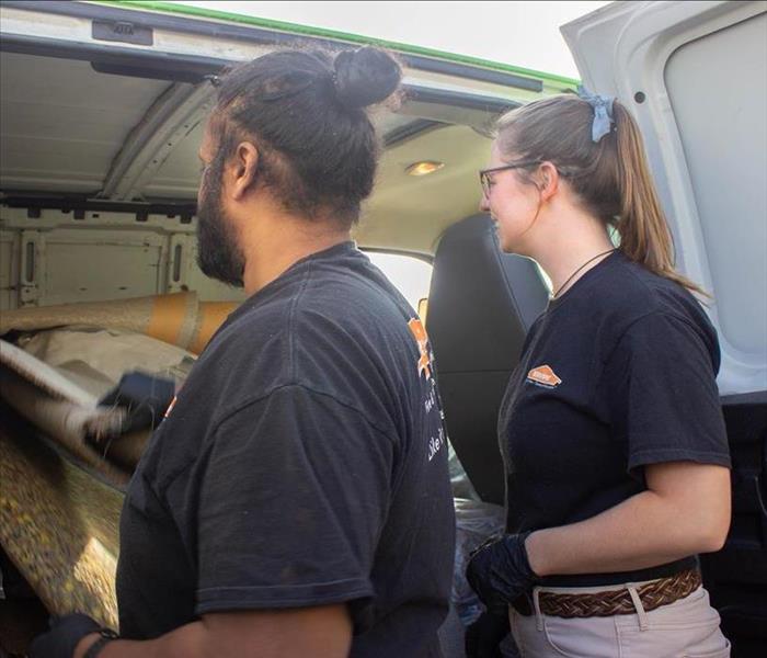 SERVPRO crew members throwing away trash