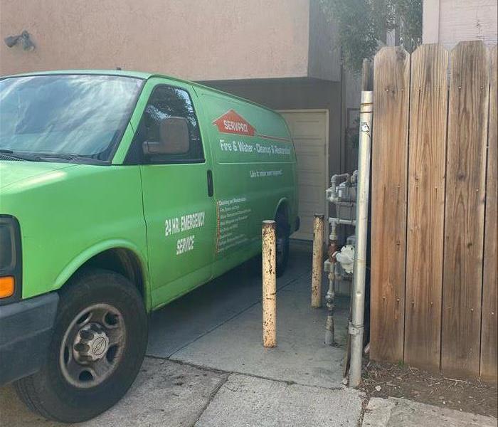 Green SERVPRO van on a residential job site.